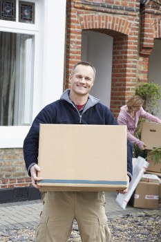 Professional packers securely packing household items